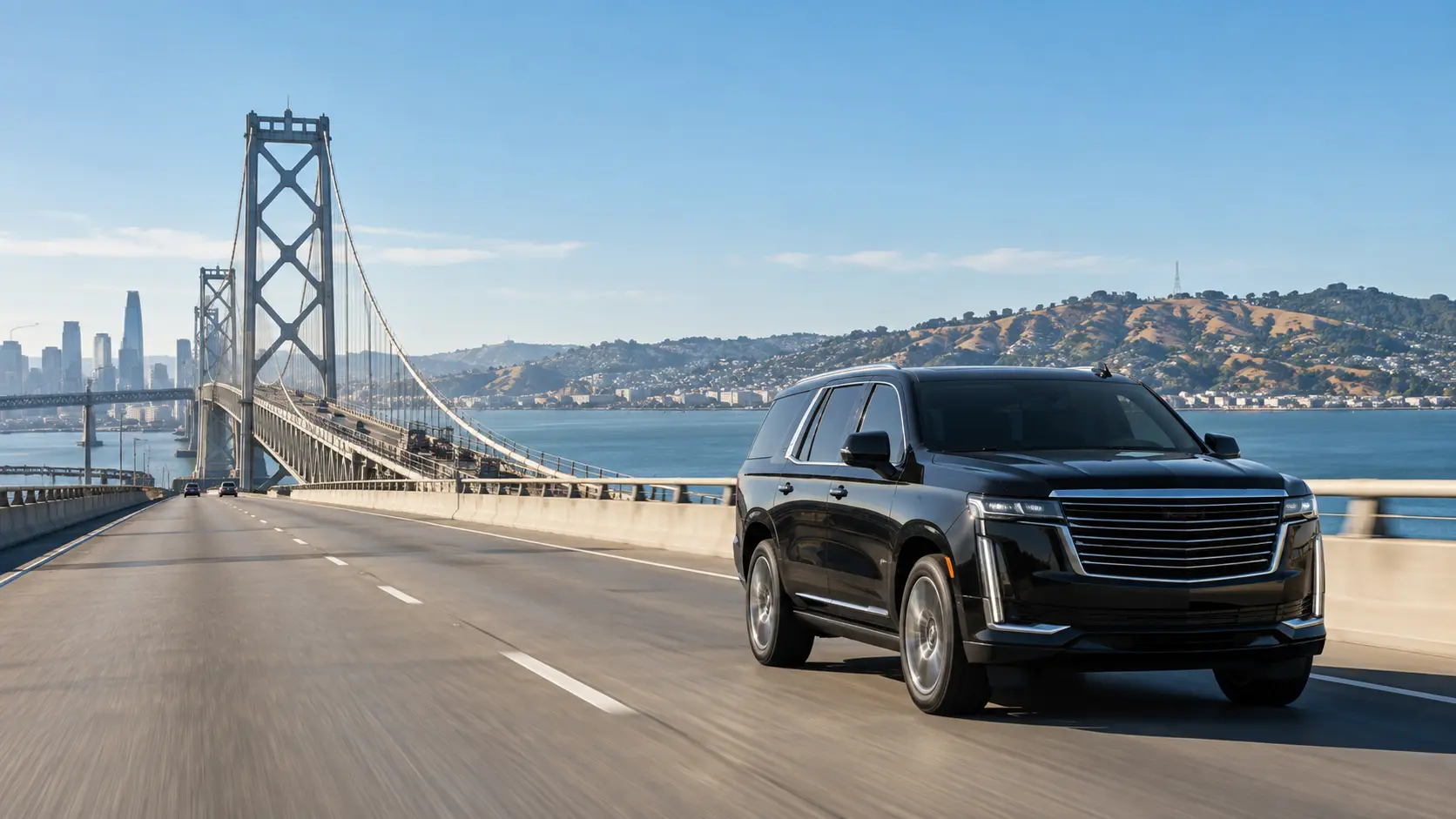 Black luxury SUV traveling toward the East Bay on the San Francisco-Oakland Bay Bridge